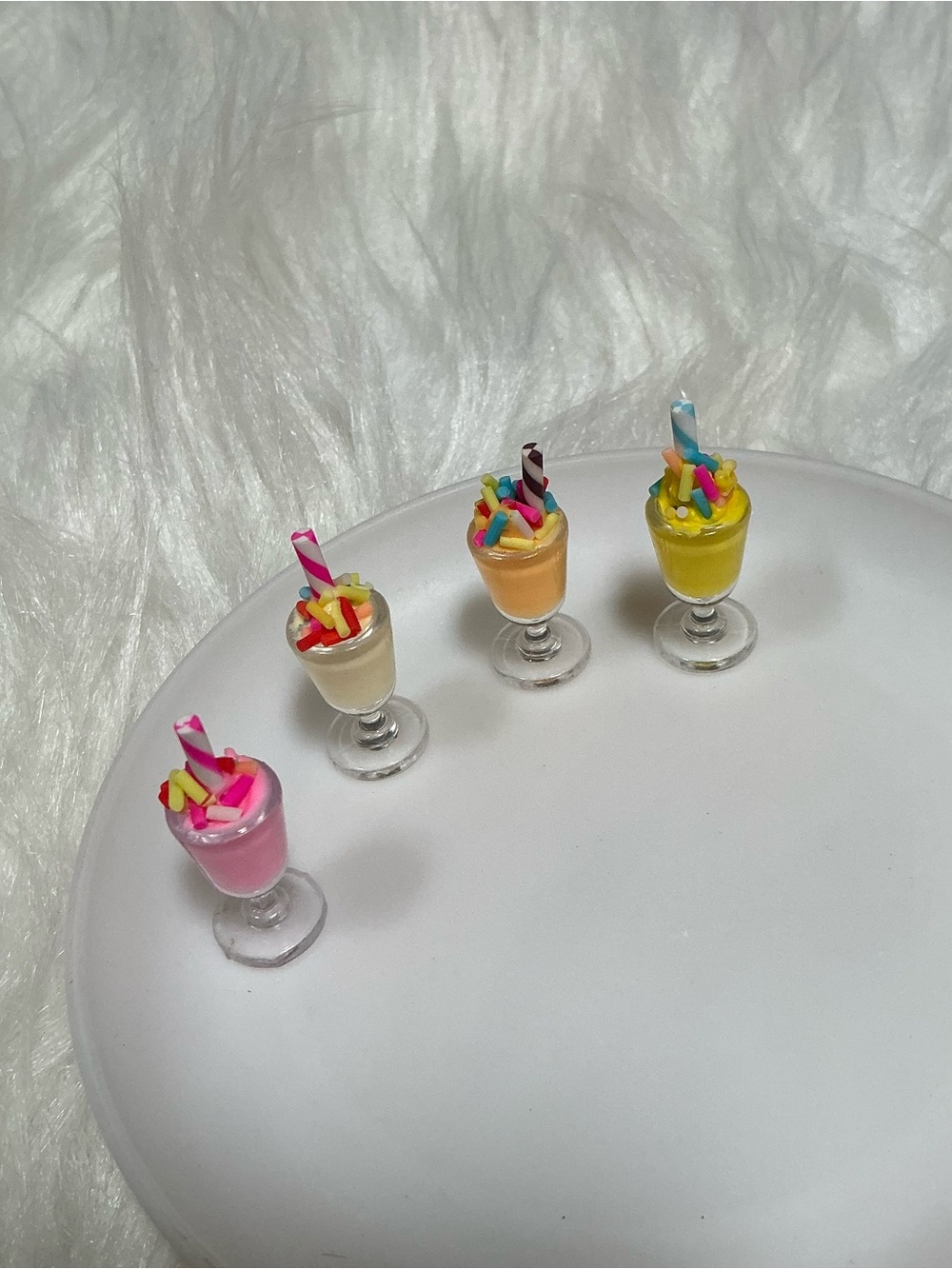 4 Miniature milkshake dessert figurines with straws and sprinkles